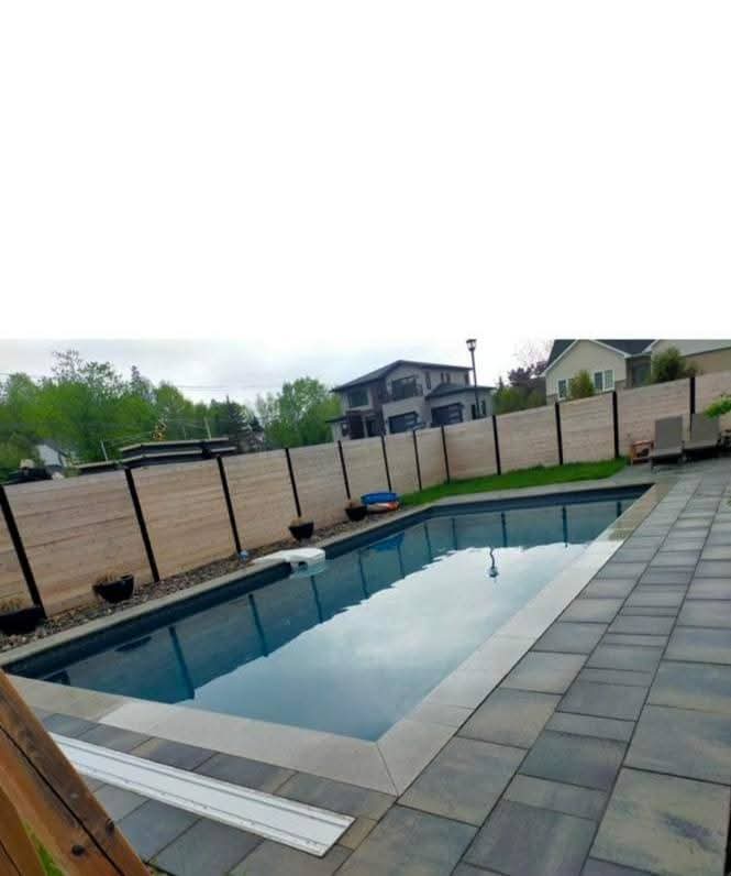 Clôture de confidentialité en bois installée autour d'une piscine